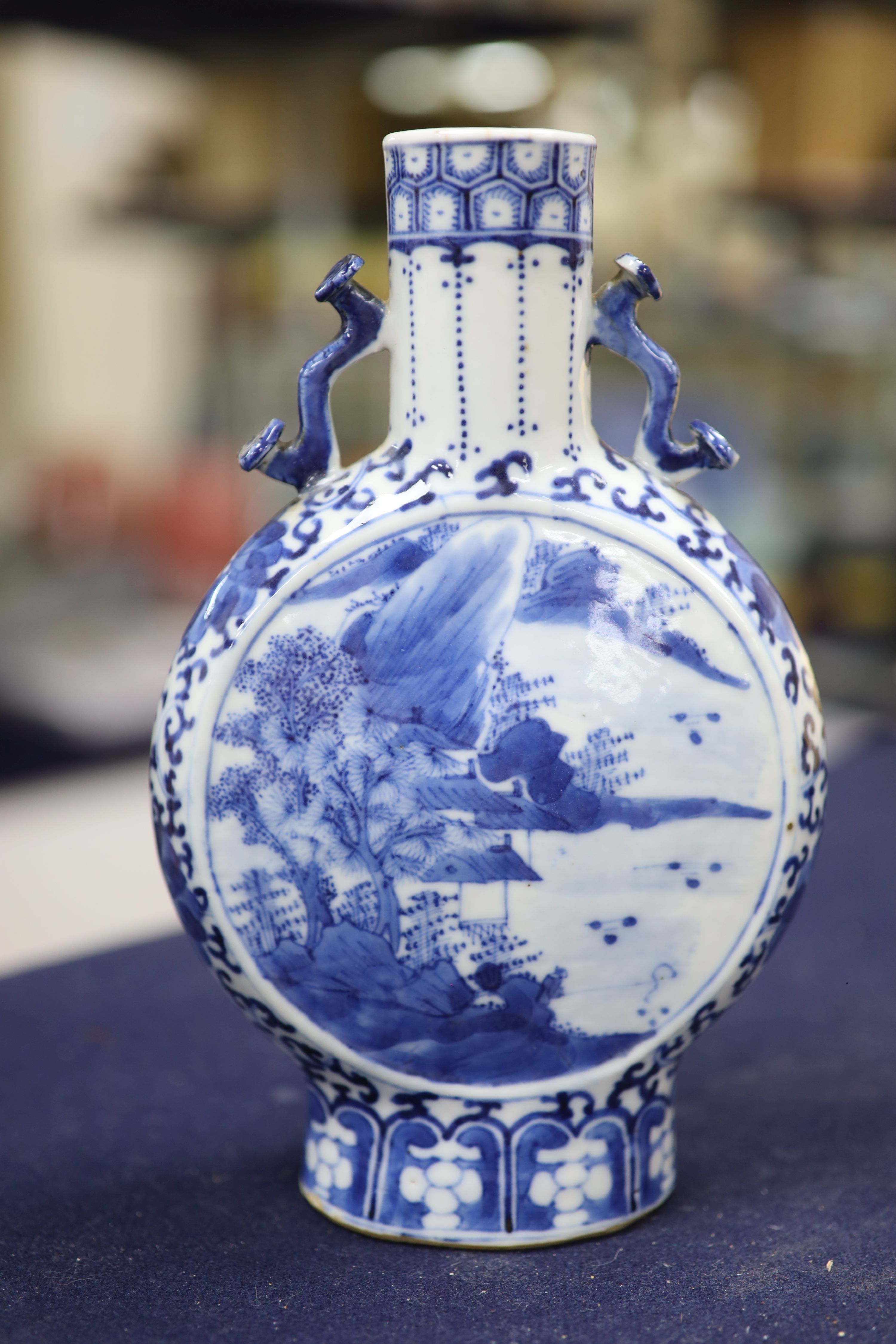 Two 19th century Chinese blue and white moon flasks and a teapot, tallest 21cm